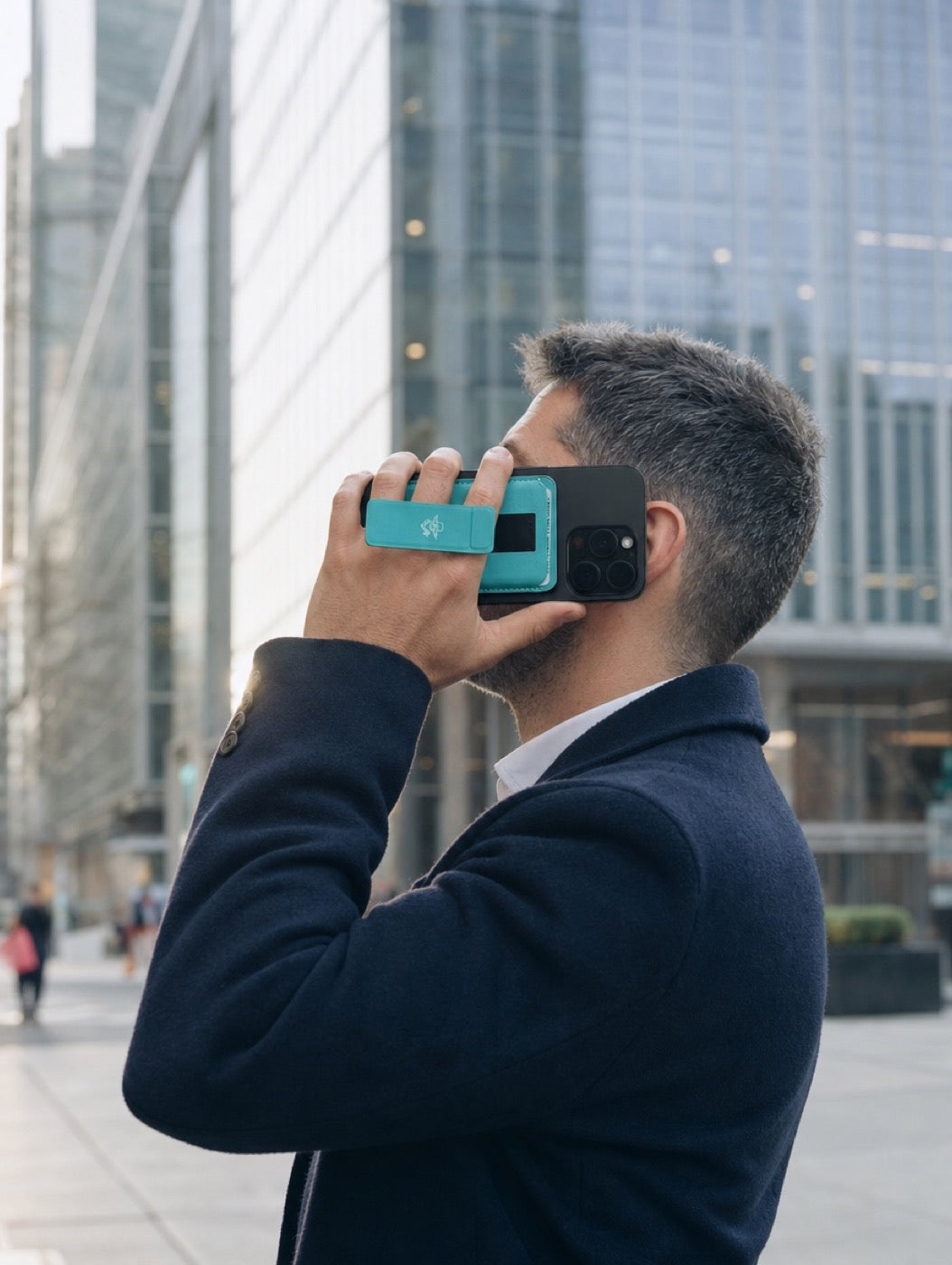 Maverick 2.0 grip holding a phone to the ear on a city street